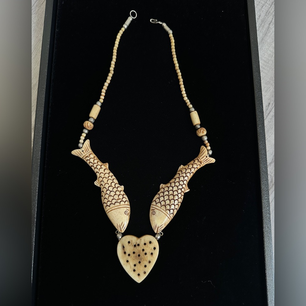 Bone necklace with hand carved fish pendants and heart centerpiece Jewelry